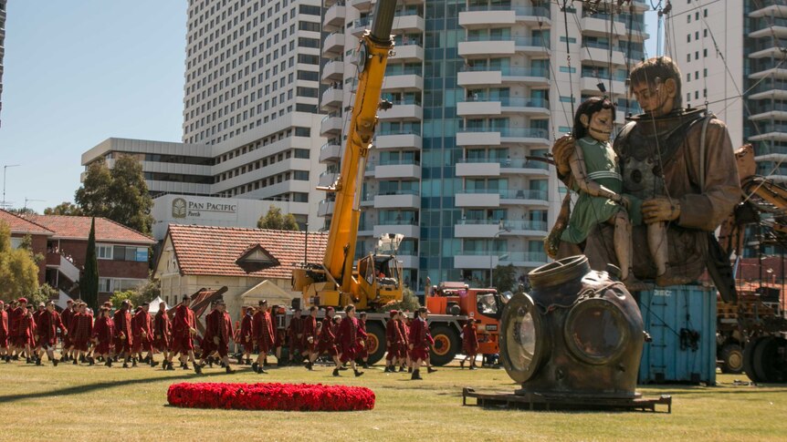 The Lilliputians arrive to wake the giants for their final walk around Perth.