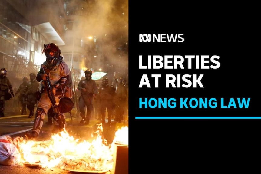 Liberties At Risk, Hong Kong Law: Riot police march amid smoke with burning rubbish in the foreground.