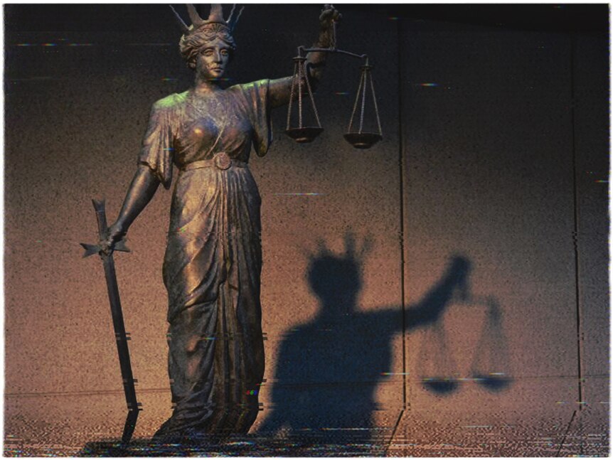 A statue holding scales of justice in front of a concrete wall. There is noticeable old TV or VHS distortion of the picture.