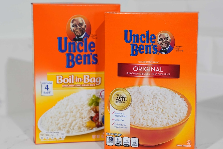 Two orange boxes of Uncle Ben's rice are seen against a white background. The boxes are orange and feature a black man.