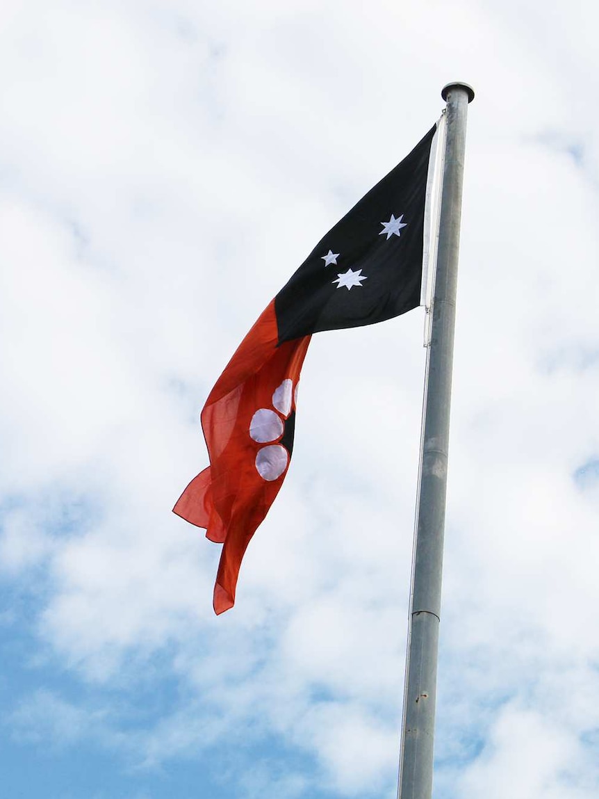 The Northern Territory flag flies above the Bagot Road overpass, in Darwin.