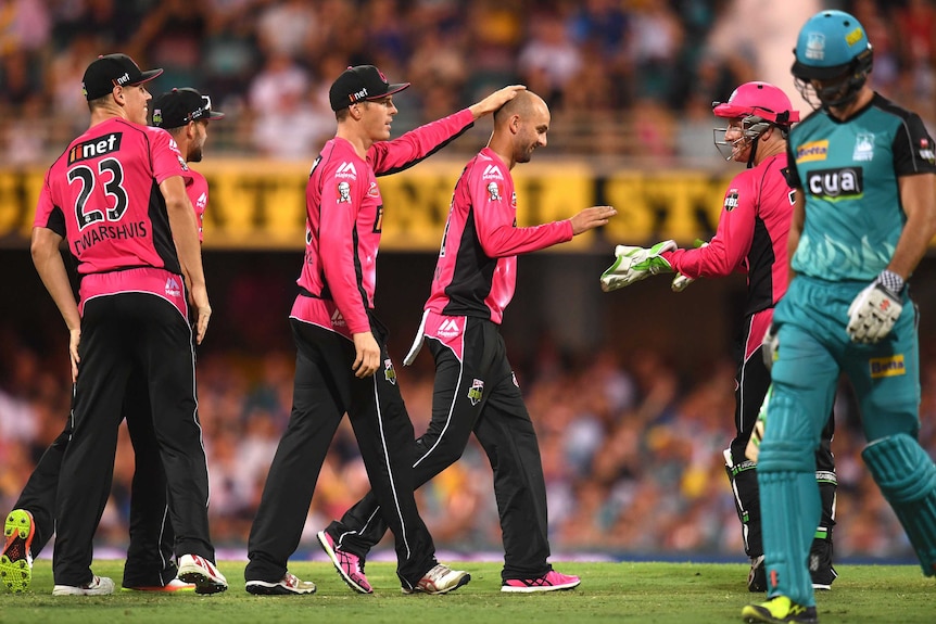 Nathan Lyon celebrates a wicket for Sydney Sixers against Brisbane Heat