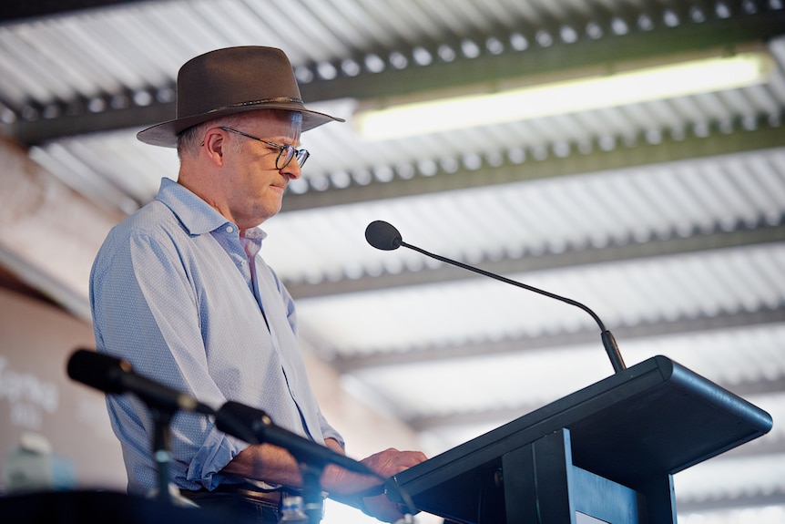 Prime Minister Anthony Albanese wearing an Akubra and speaking from a lectern.