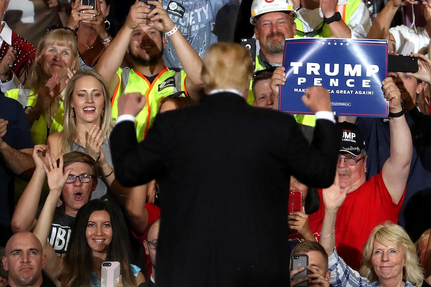 U.S. president Donald Trump greets supporters during a campaign rally in Montana