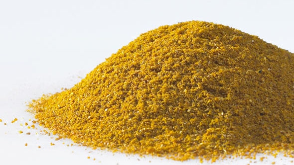 Yellow curry powder on a white background