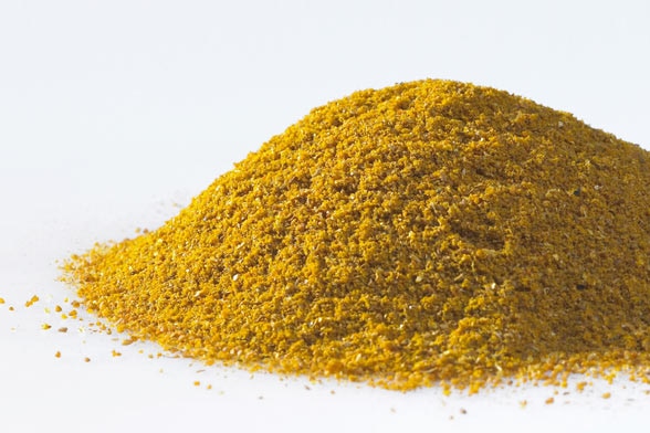 Yellow curry powder on a white background
