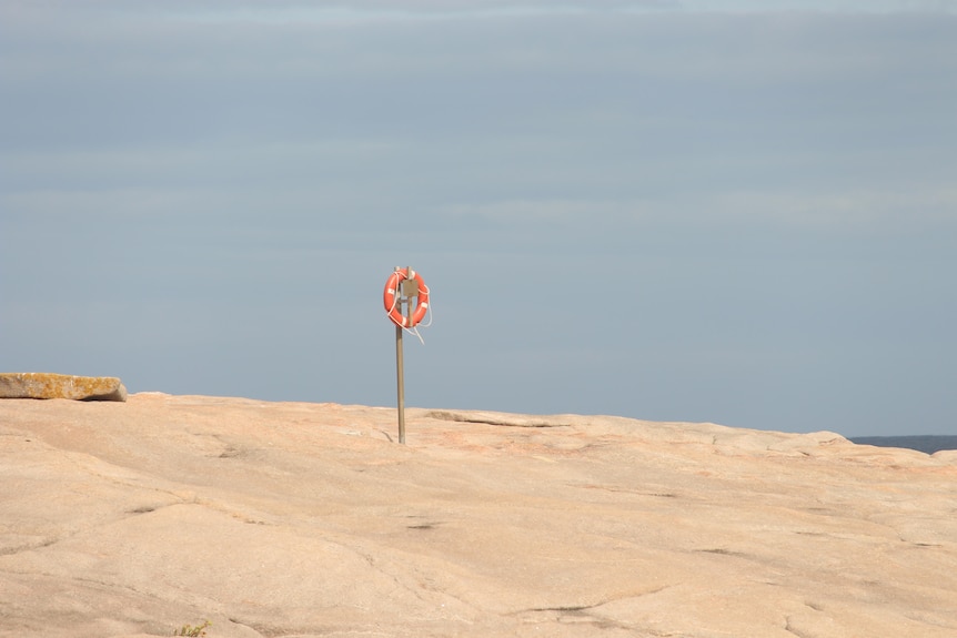 A life ring on a wooden pole at Salmon Beach