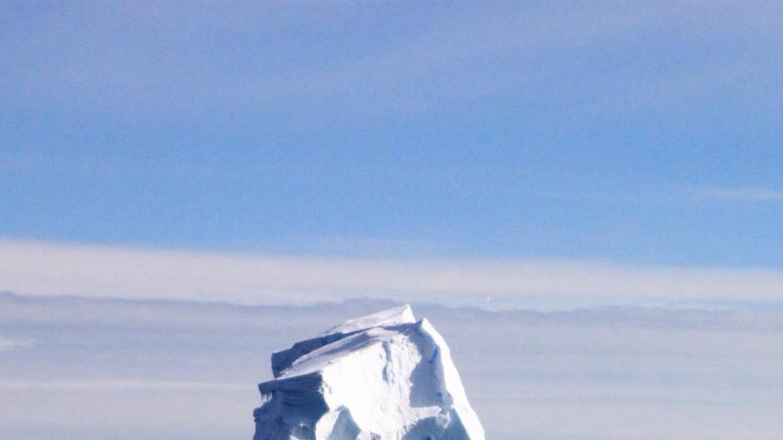 An iceberg sits in the waters surrounding Antarctica