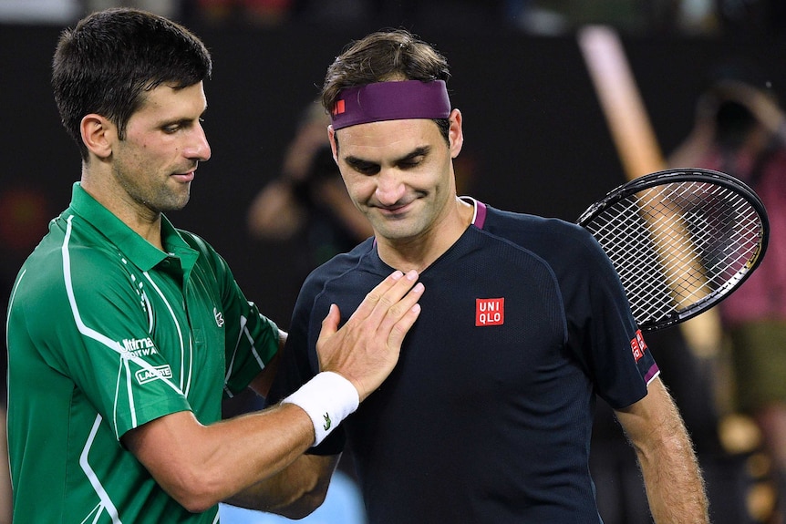 Two male tennis players congratulate each other at the net after their Australian Open tennis match.