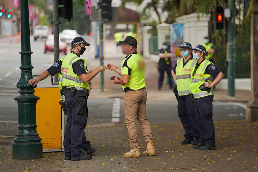 Police speak with a man.