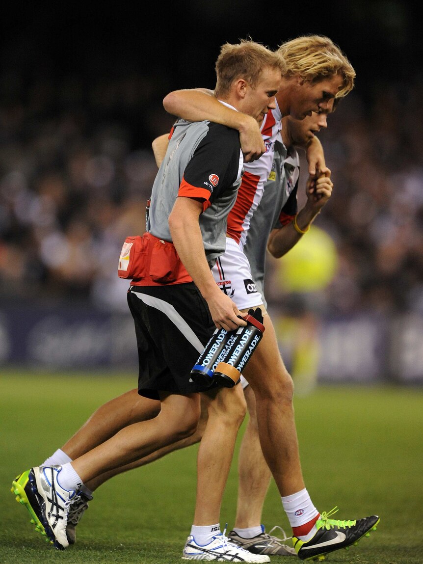 St Kilda's Sam Gilbert comes off the ground with a knee injury against Collingwood at Docklands.