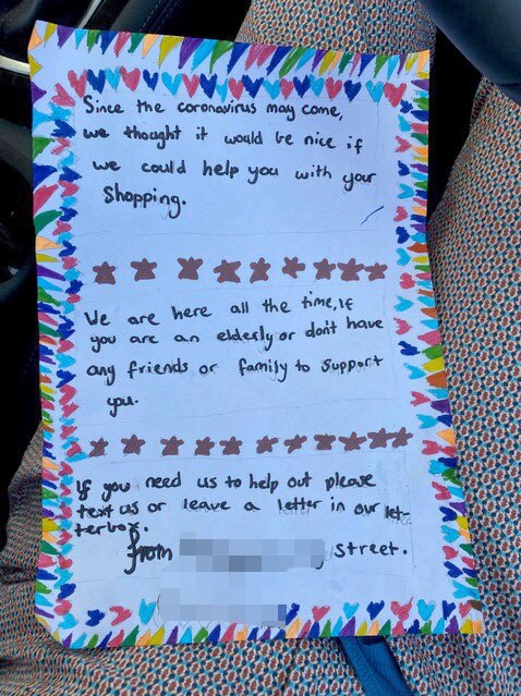 A brightly decorated letter in a child's hand offering help to neighbours.