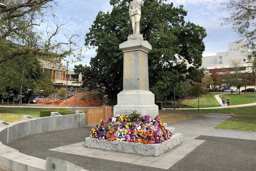 Wreaths and flowers at the foot of the Cenotaph at Box Hill.