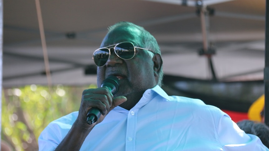 Galarrwuy Yunupingu speaks wearing sunglasses and a blue shirt