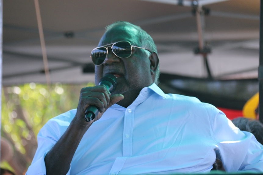 Galarrwuy Yunupingu speaks wearing sunglasses and a blue shirt