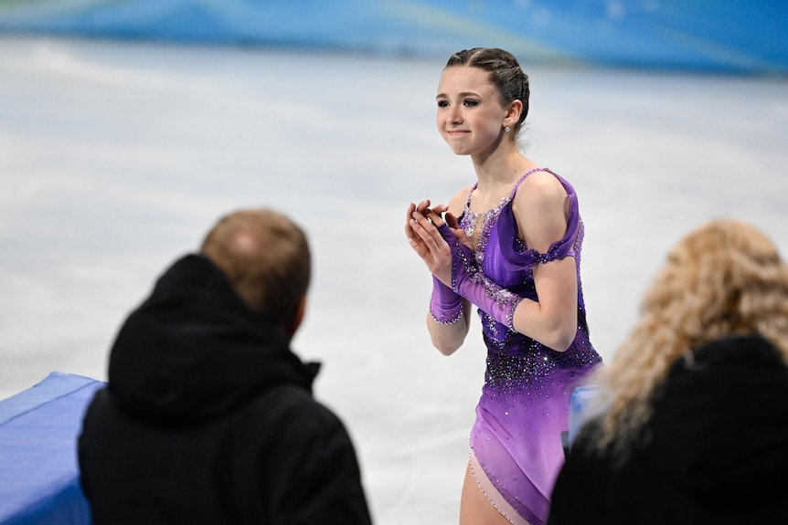 A Russian female skater smiles at the crowd after completing a routine at the Winter Olympics.