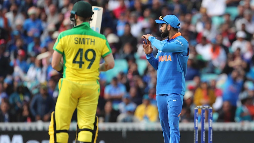 The Indian captain makes the "T" signal to ask for umpire's review during a Cricket World Cup game.