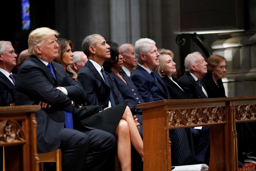The current and former presidents sit in the front row at George HW Bush's funeral