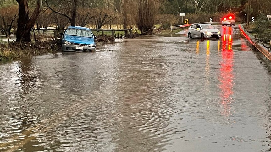 Cars stranded on a flooded road.