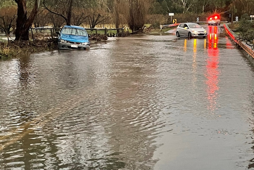 Cars stranded on a flooded road.
