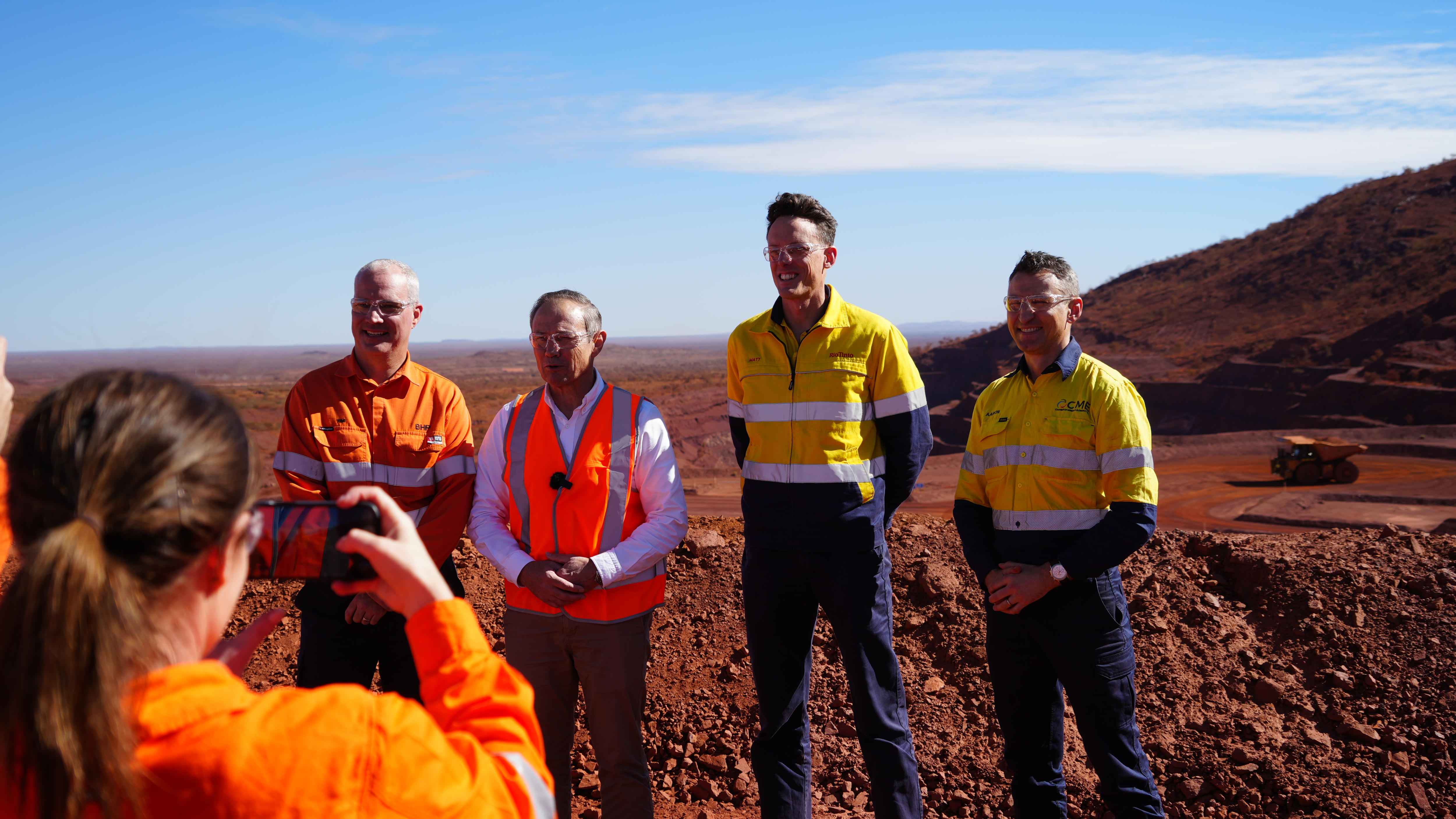 Premier Roger Cook pauses for a photo with executives from Rio Tinto and Caterpillar.