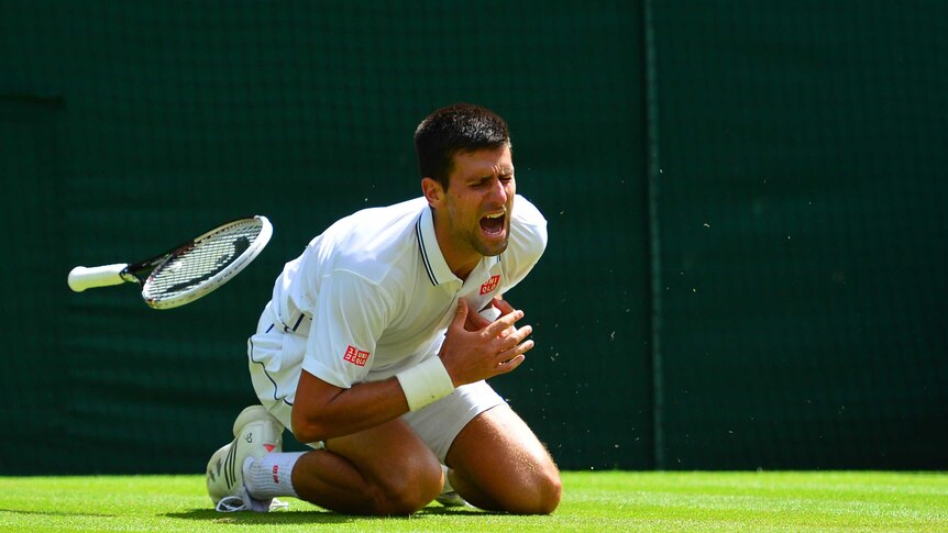 Serbia's Novak Djokovic falls against Gilles Simon at Wimbledon on June 27, 2014.