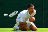 Serbia's Novak Djokovic falls against Gilles Simon at Wimbledon on June 27, 2014.