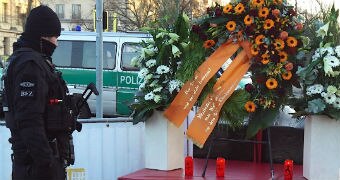 A policeman observes a tribute to the Berlin truck attack victims.