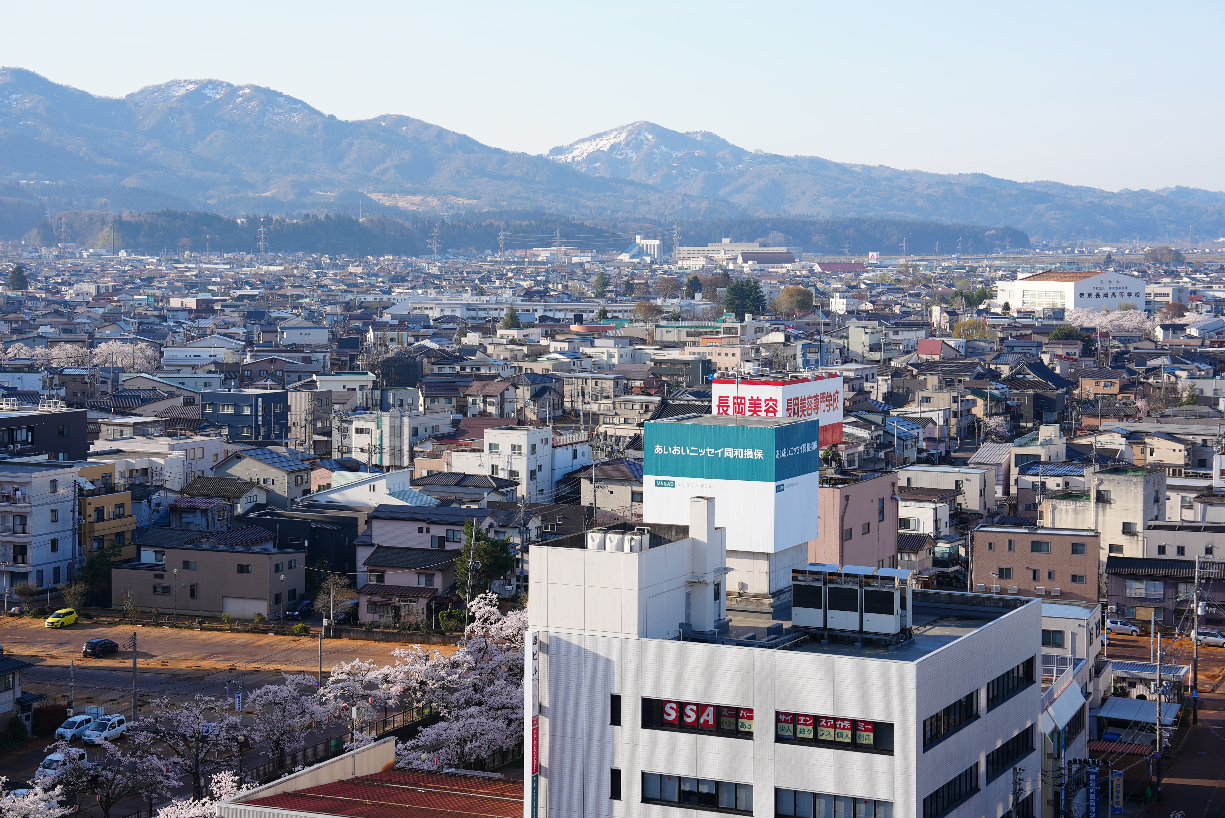 A birds-eye view of buildings and mountains in Japan.