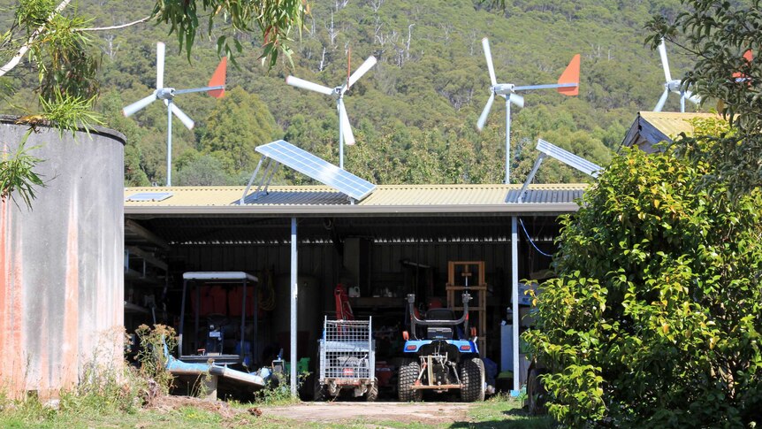 Solar panels and wind turbines on a shed