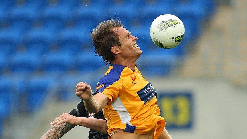 Aerial contest ... Dylan Macallister of Gold Coast United heads the ball (Chris Hyde: Getty Images)