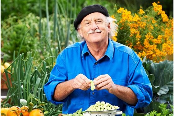 A person sitting in a garden preparing food