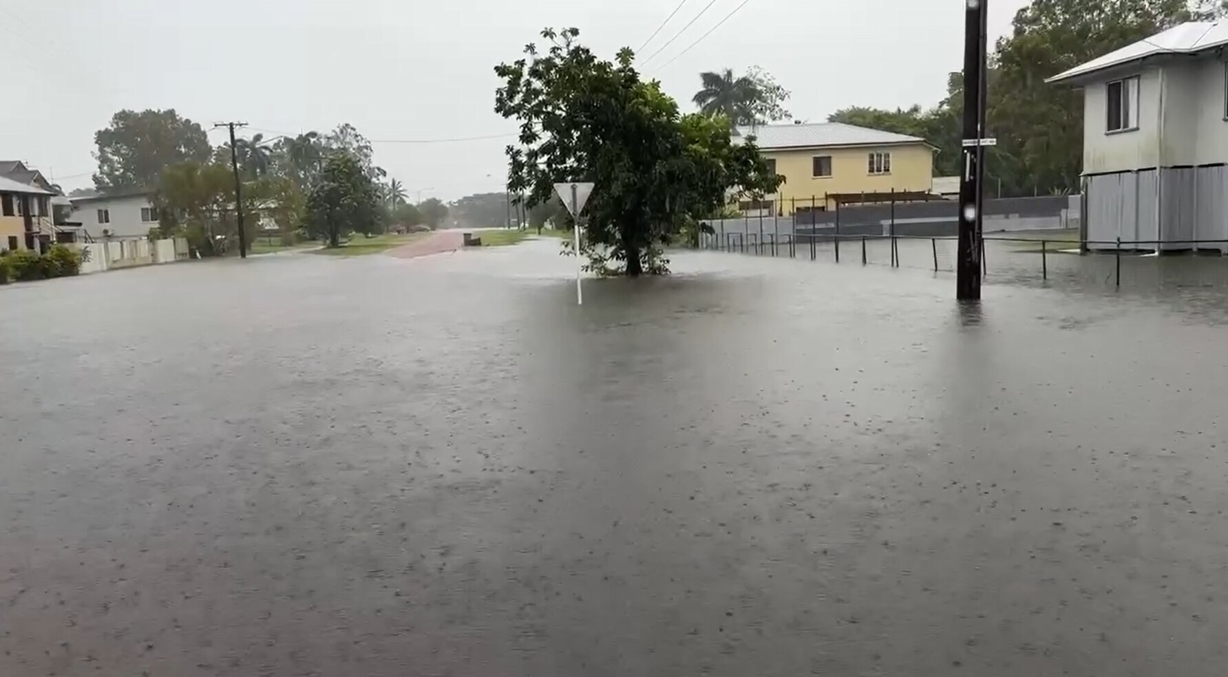 Water across the road at Ingham at 2pm on Saturday - ABC News