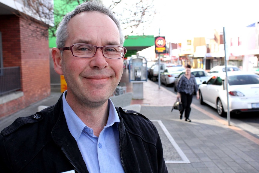 Allan Whyke standing on the main street of Moonah.