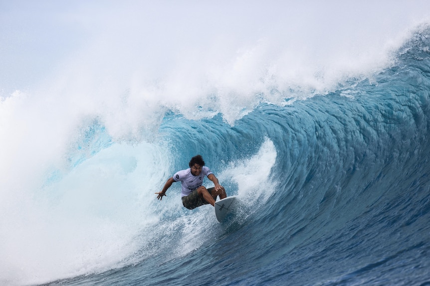 Pro sufer Matahi Drollet riding a barrel in the surf.