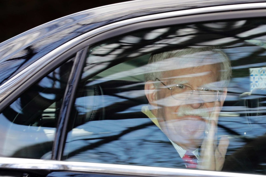 Former National security adviser John Bolton waves as he leaves his home