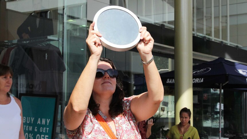 A woman with a circular lens disc