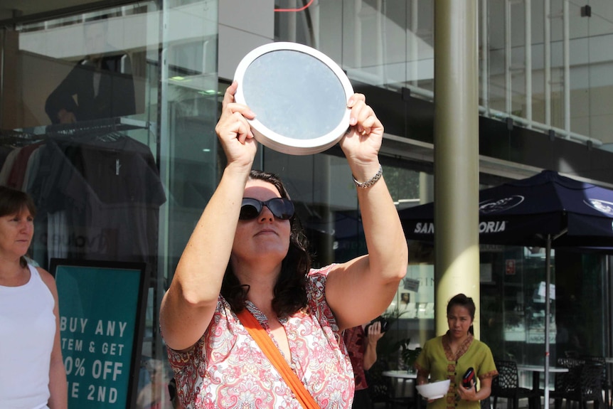 A woman with a circular lens disc