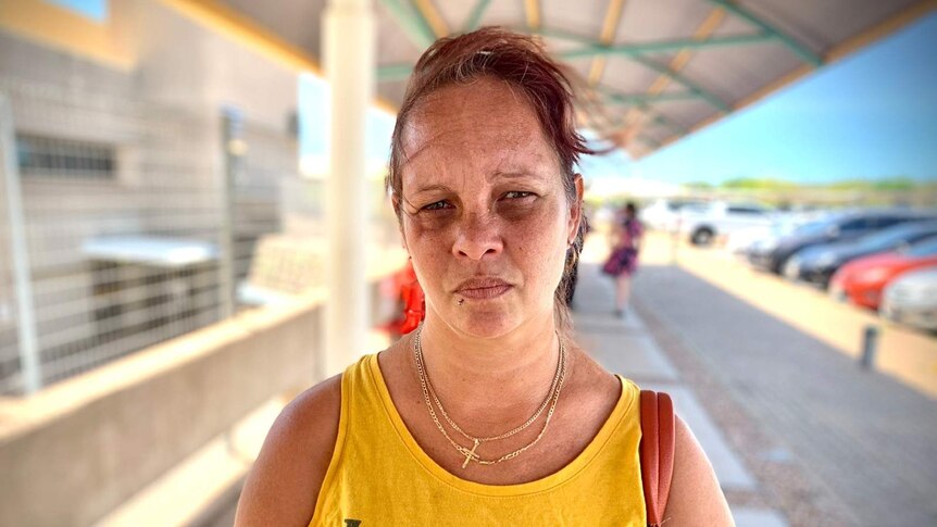 A photo of Darwin mother Kylie Calma looking concerned as she stands outside the Darwin hospital.