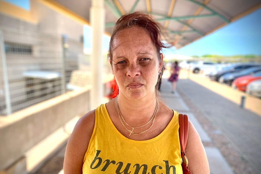 A photo of Darwin mother Kylie Calma looking concerned as she stands outside the Darwin hospital.