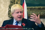 Boris Johnson gestures during a news conference