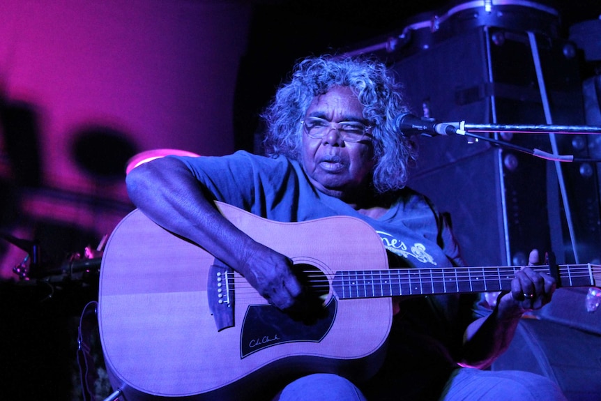 Olive Knight on stage with her guitar during the Desert Feet tour