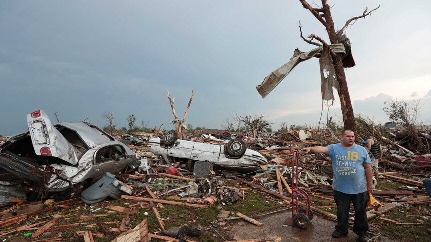 Philip Gotcher stands in the rubble of his house after a powerful tornado ripped through Oklahoma.