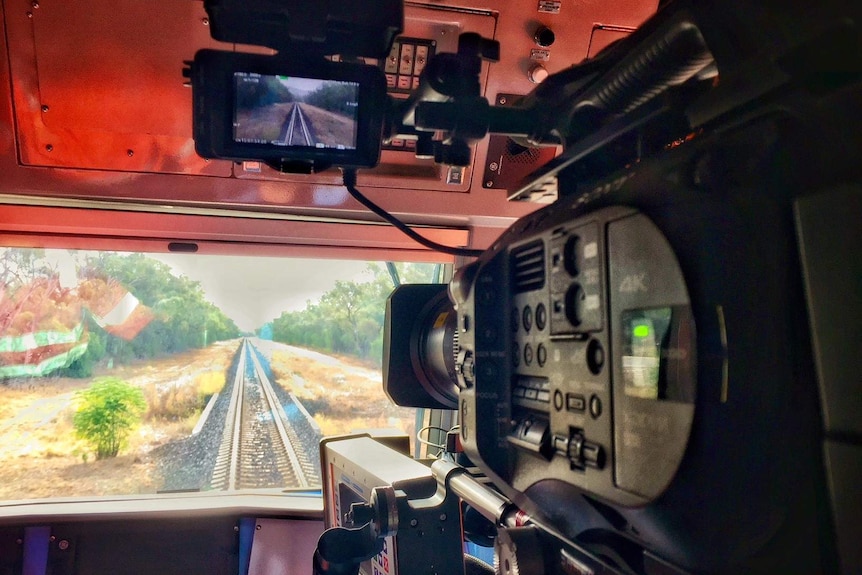 Camera inside train filming tracks up ahead.