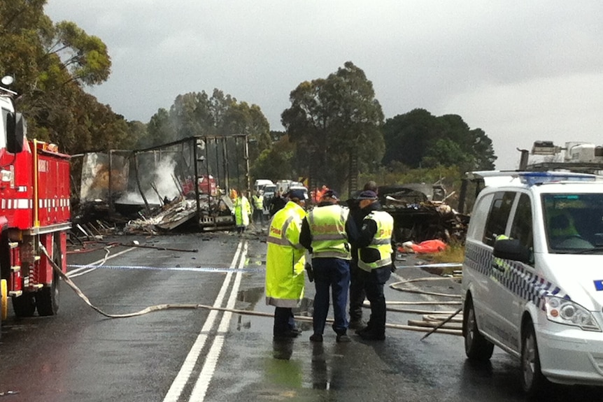 Police at the scene in daylight of the three truck crash at Stawell, Victoria