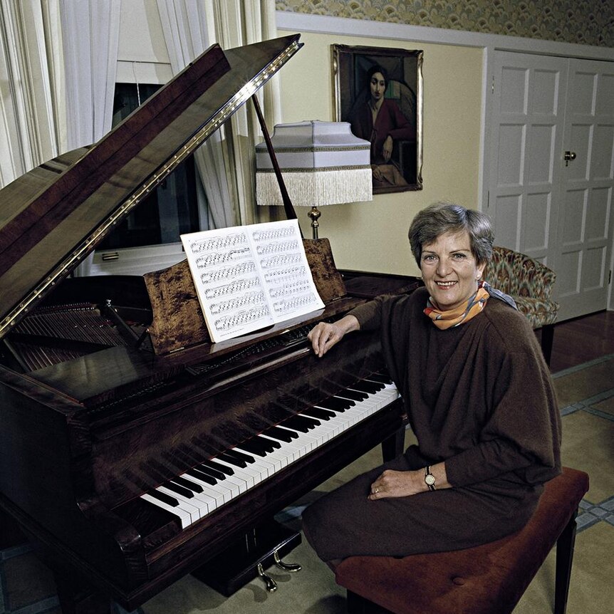 Hazel Hawke sitting at a piano at the Lodge.