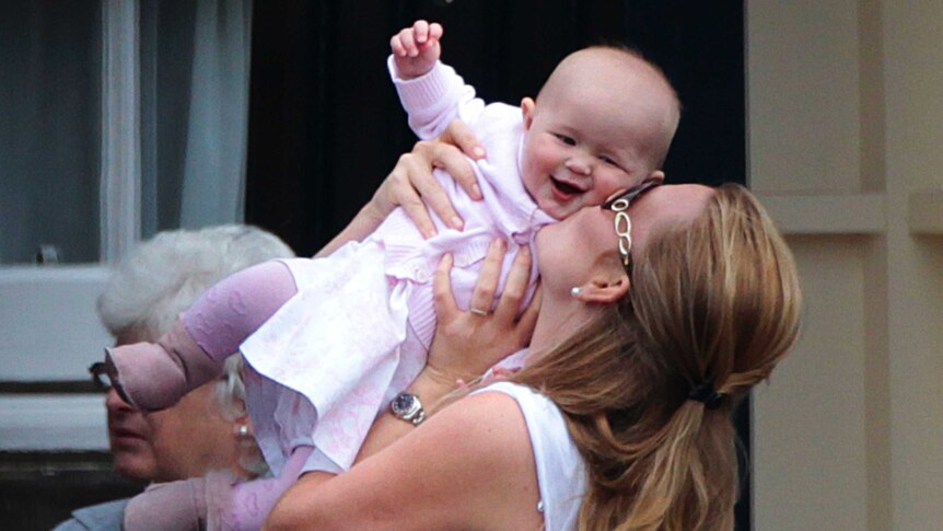 Peter Phillips' wife Autumn kisses their daughter Savannah in 2011.