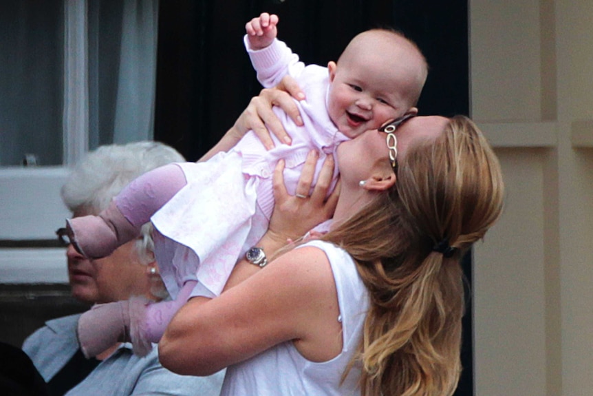 Peter Phillips' wife Autumn kisses their daughter Savannah in 2011.