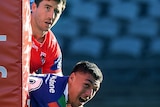 Ben Hunt looks sad and Jamayne Taunoa-Brown looks happy after the latter score a try for the Warriors in the NRL.