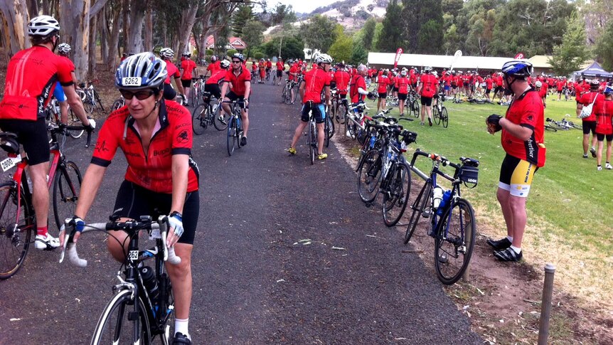 Riders mill around at a rest stop north of Adelaide during in the community challenge ride.